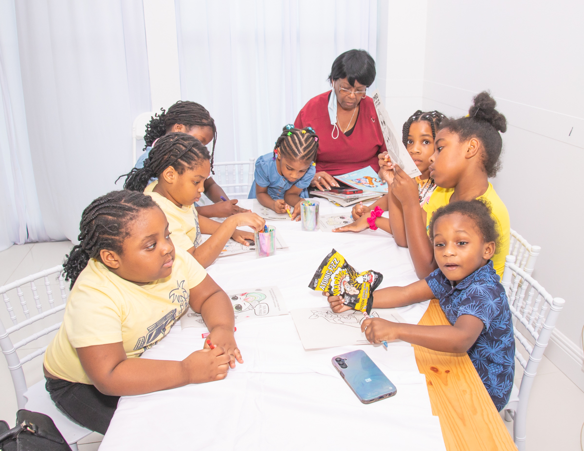 Children coloring at a table during the children's activity corner