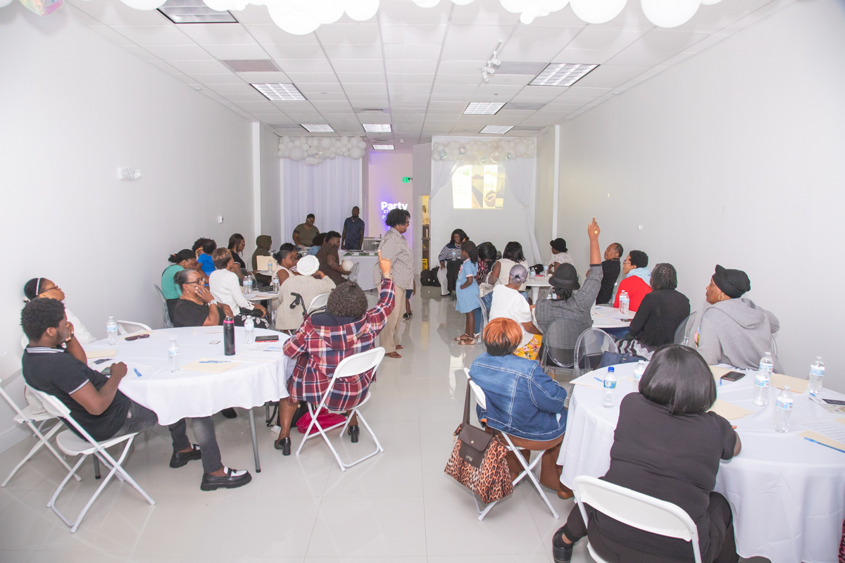 Parent raising a hand to ask a question during the training